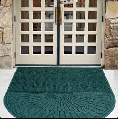 Commercial entryway floor mat outside a doorway