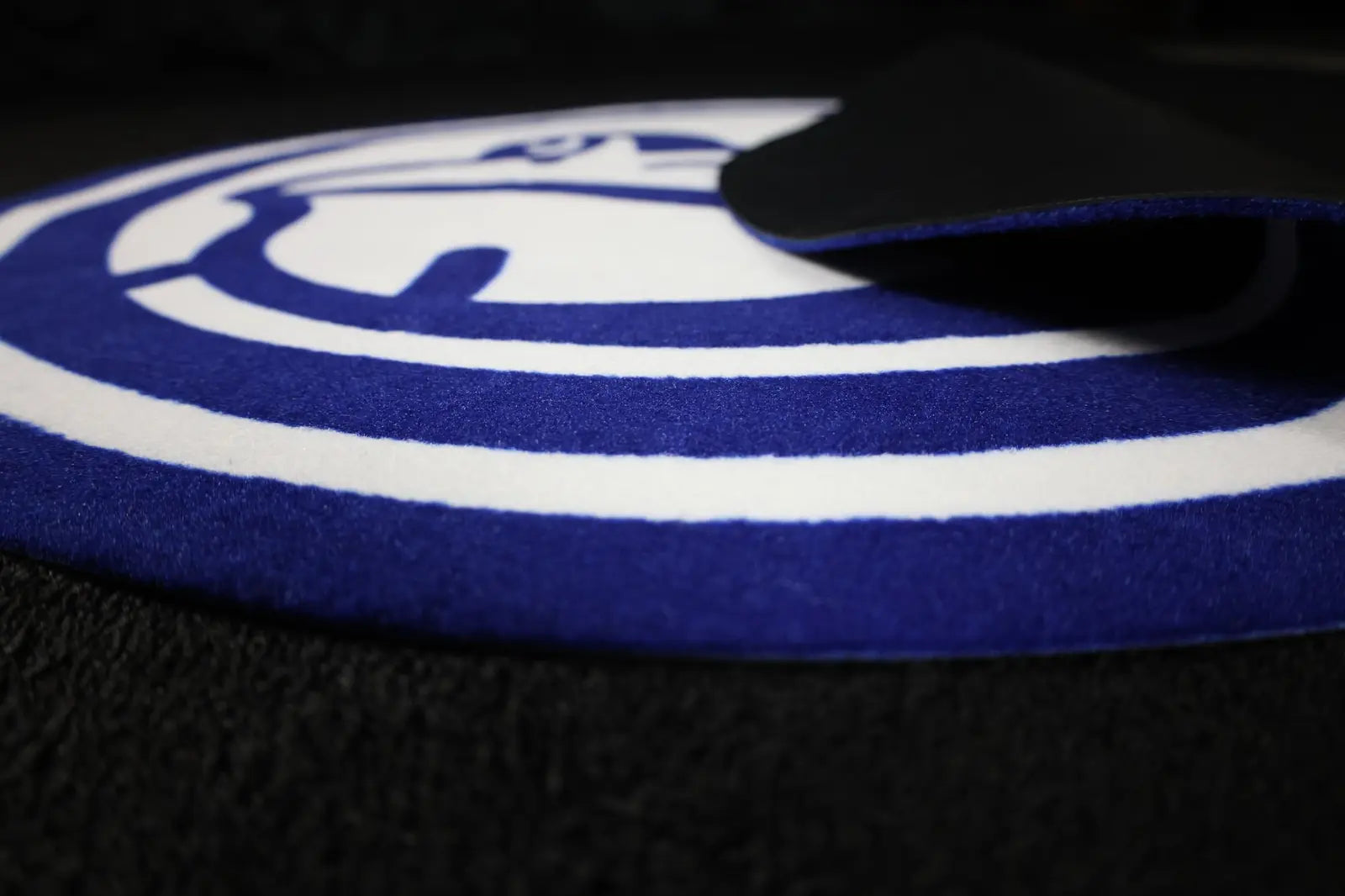 Blue and white custom-shaped logo mat detail