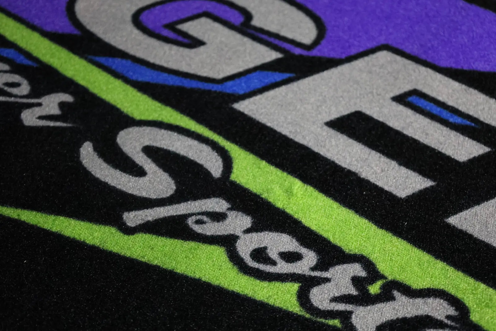 Green, purple, and black custom printed mat detail